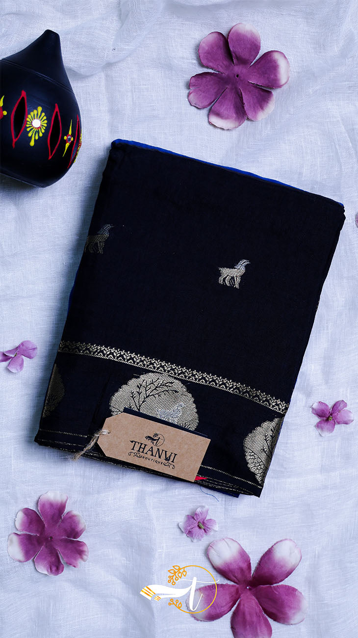 Black saree with silver embroidery on a white background with purple flowers