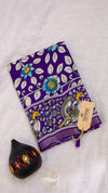 Purple fabric with floral and bird pattern on a light gray background