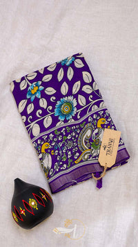 Purple fabric with floral and bird pattern on a light gray background