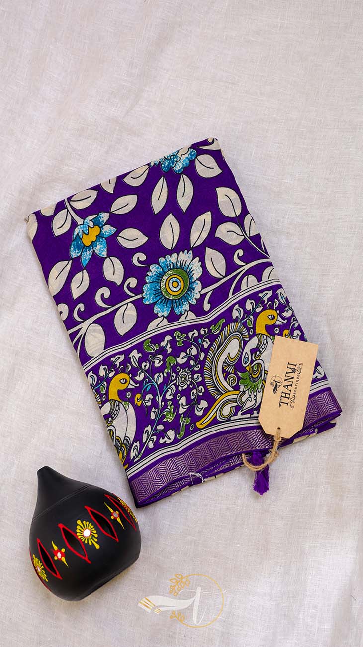 Purple fabric with floral and bird pattern on a light gray background