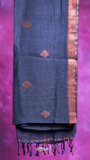 Blue fabric with red floral patterns and black tassels on a purple background