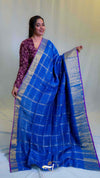 Woman holding a blue saree with a white background