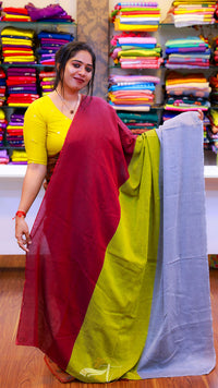 Woman holding a colorful saree in a fabric store