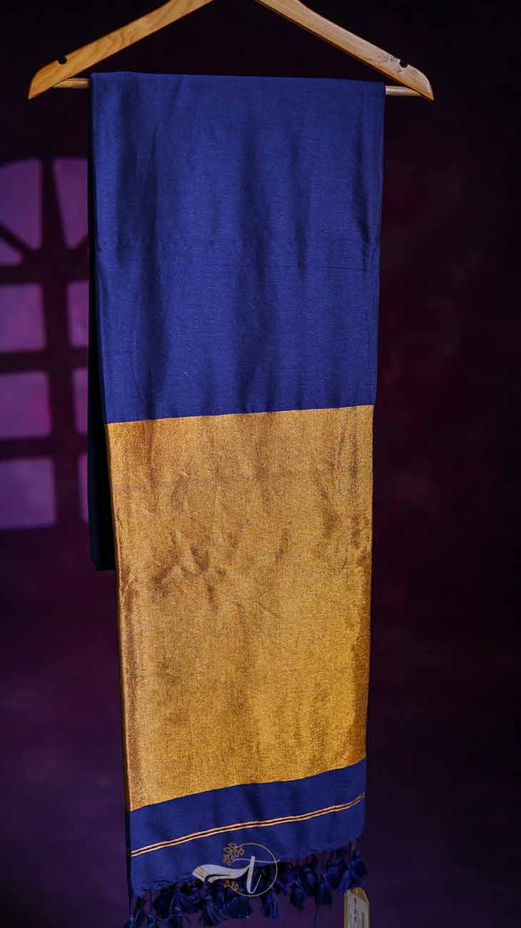 Blue and gold scarf with tassels on a wooden hanger against a dark background