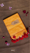 Yellow fabric package with a brand label on a brown background with flowers.