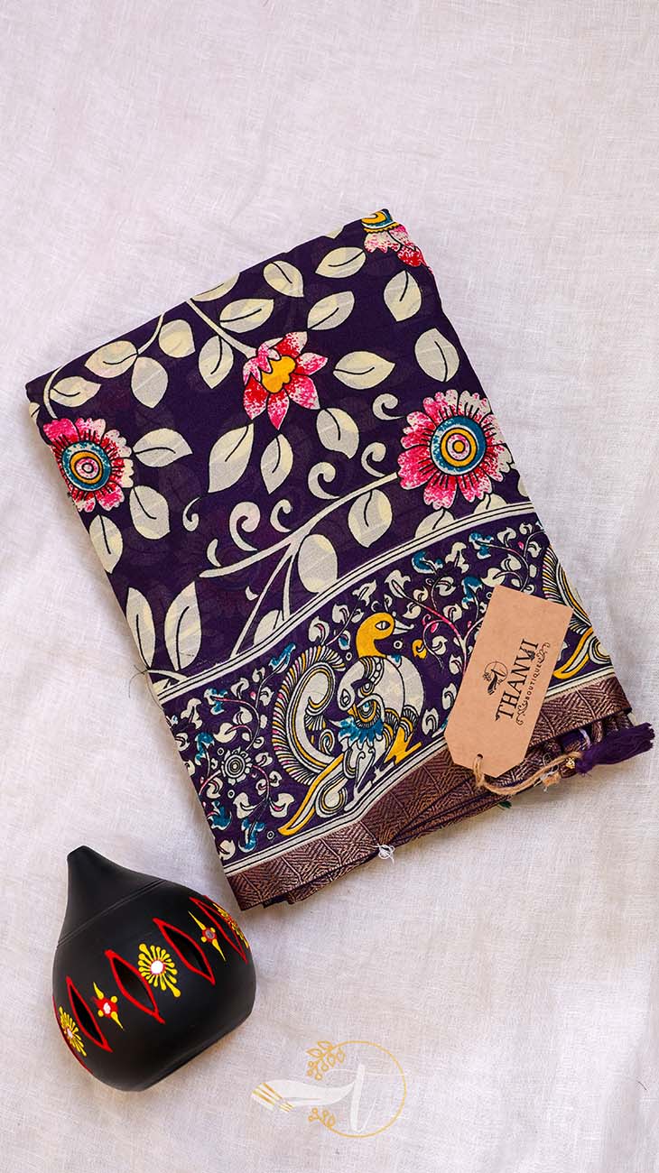 Colorful fabric with floral patterns and a black decorative item on a light background