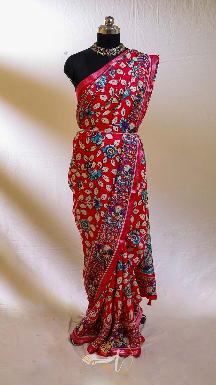 Red saree with floral patterns on a mannequin against a white background