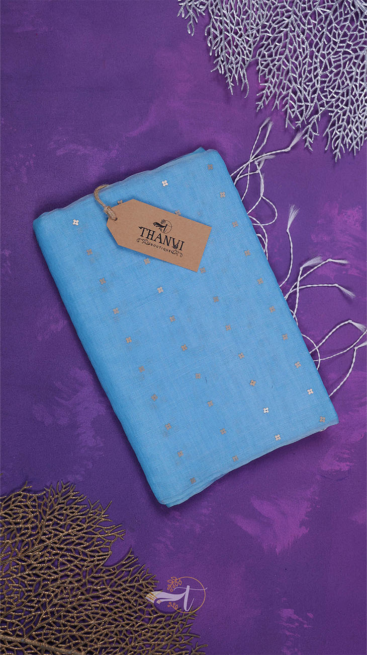 Blue fabric with gold polka dots on a purple background