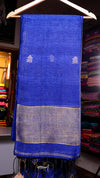 Blue fabric with white patterns on a hanger against a colorful background