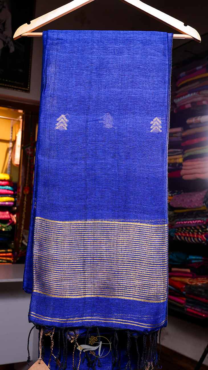Blue fabric with white patterns on a hanger against a colorful background