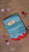 Blue fabric with red floral trim on a brown background