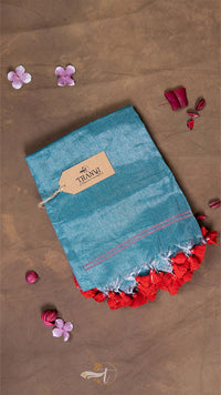 Blue fabric with red floral trim on a brown background