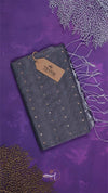 Gray fabric with gold patterns on a purple background, featuring a brand tag.