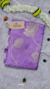 Purple scarf with floral patterns on a light gray background, featuring a Thani brand tag.