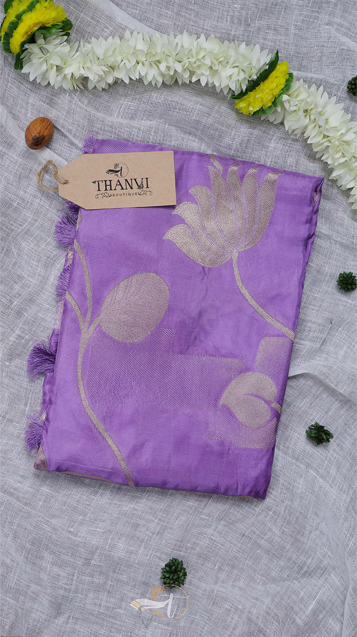 Purple scarf with floral patterns on a light gray background, featuring a Thani brand tag.