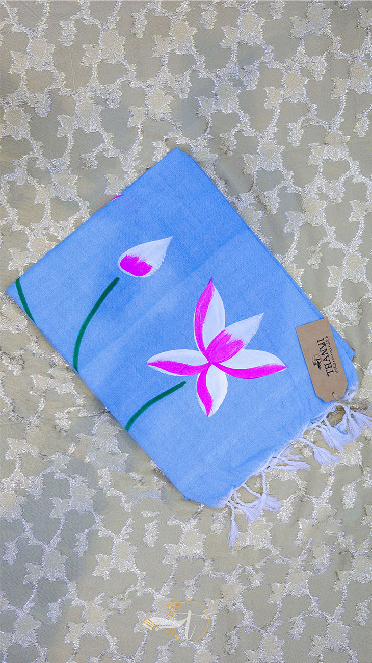 Blue towel with pink flower design on a textured surface