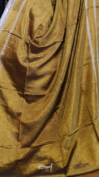 Brown fabric with a visible brand logo on a wooden surface