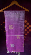 Purple fabric with gold patterns on a wooden hanger against a dark background