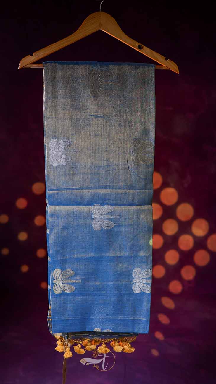 Blue fabric with white patterns on a hanger against a dark background