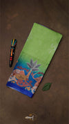 Green fabric with colorful embroidery on a brown background