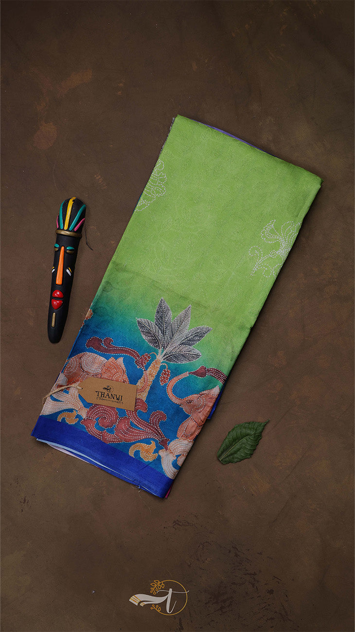 Green fabric with colorful embroidery on a brown background