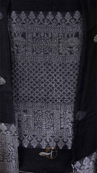 Close-up of a patterned fabric with intricate designs on a dark background