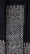 Close-up of a textured fabric with intricate patterns on a dark background