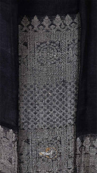 Close-up of a textured fabric with intricate patterns on a dark background