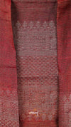Close-up of a red fabric with intricate patterns and designs.