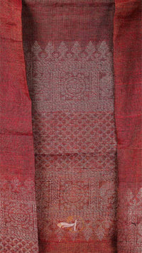 Close-up of a red fabric with intricate patterns and designs.