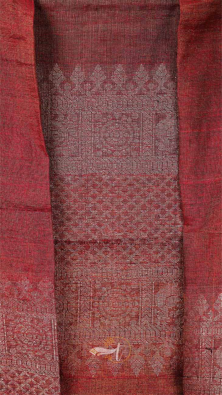 Close-up of a red fabric with intricate patterns and designs.