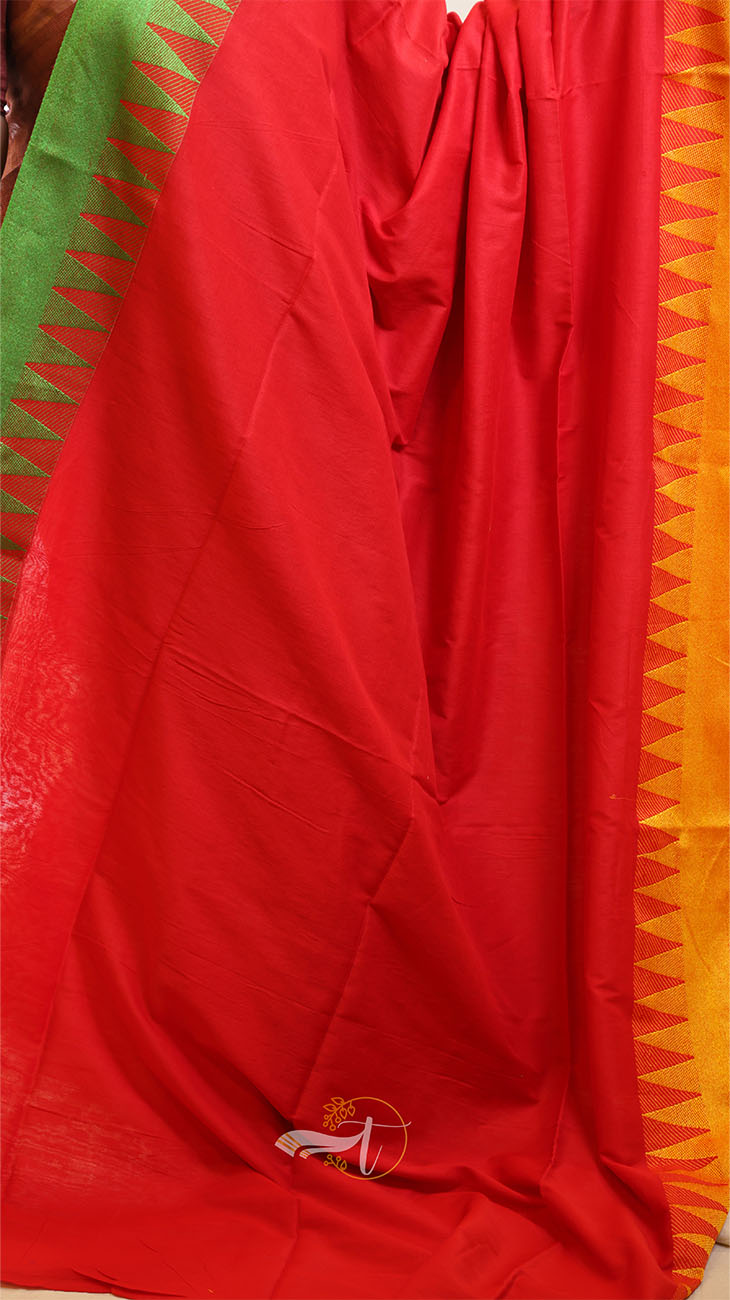 Red fabric with green and orange patterns in the background