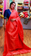 Woman wearing a red saree with a blue blouse in a store setting