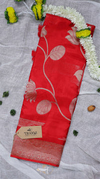 Red fabric with floral patterns on a gray background