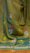 Green fabric with floral embroidery on a colorful background