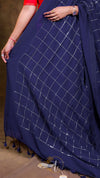 Navy blue fabric with white grid pattern draped over a surface.
