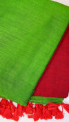 Green and red fabric with tassels on a white background