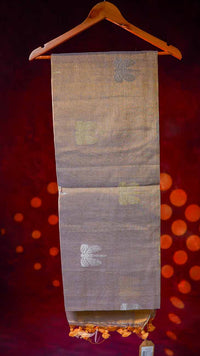 Saree on a hanger against a red background with a blurred pattern