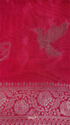 Red fabric with intricate white patterns and a bird design.