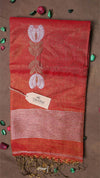 Red scarf with white floral design and fringes on a brown background