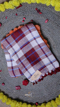 Plaid fabric with red and white pattern on a textured surface