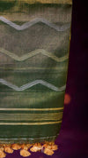 Green fabric with white zigzag pattern on a purple background