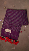 Purple scarf with white stripes and red tassels on a brown background