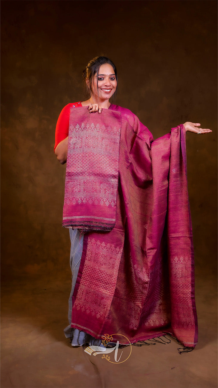 Woman in a traditional outfit with a pink saree on a brown background