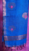 Blue fabric with peacock feather patterns on a pink background