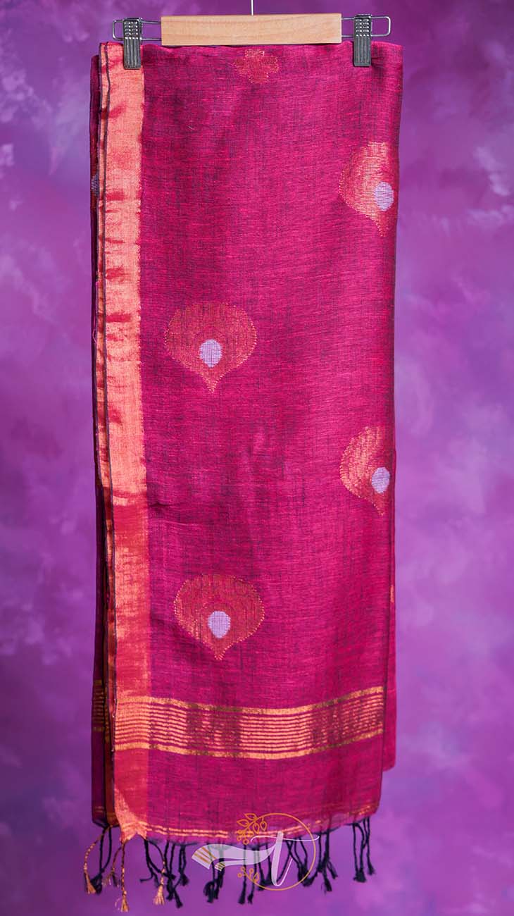 Red scarf with patterns on a wooden hanger against a purple background