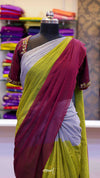 Saree with maroon and green colors on a mannequin against a colorful fabric background