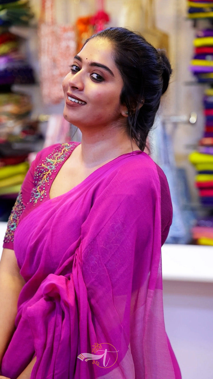 Woman wearing a pink saree with a colorful background