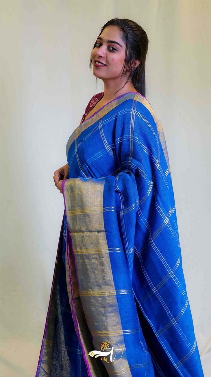 Woman wearing a blue saree with a white background