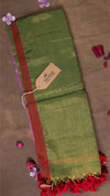 Green fabric with red border and decorative elements on a brown background